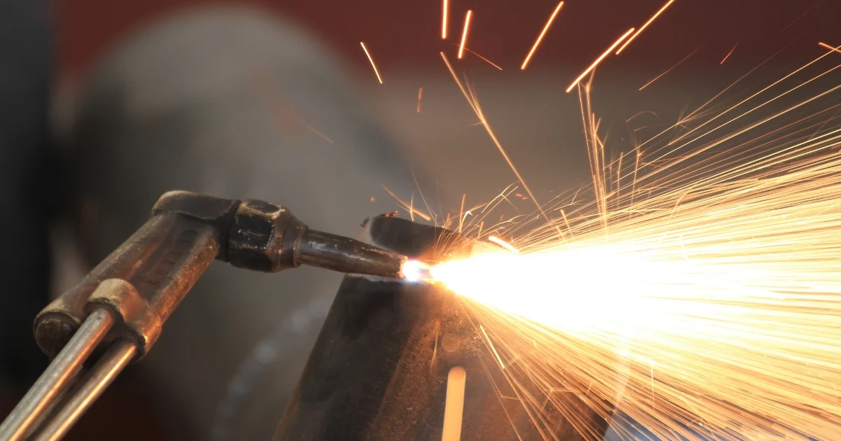 Torch cutting metal with sparks